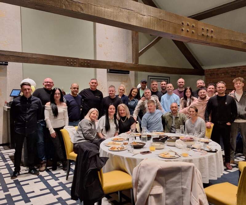 The Seasons team gathered around a dinner table at a restaurant