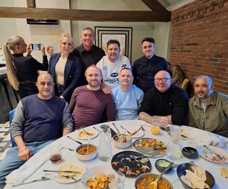 Members of the Seasons team smiling around a restaurant table