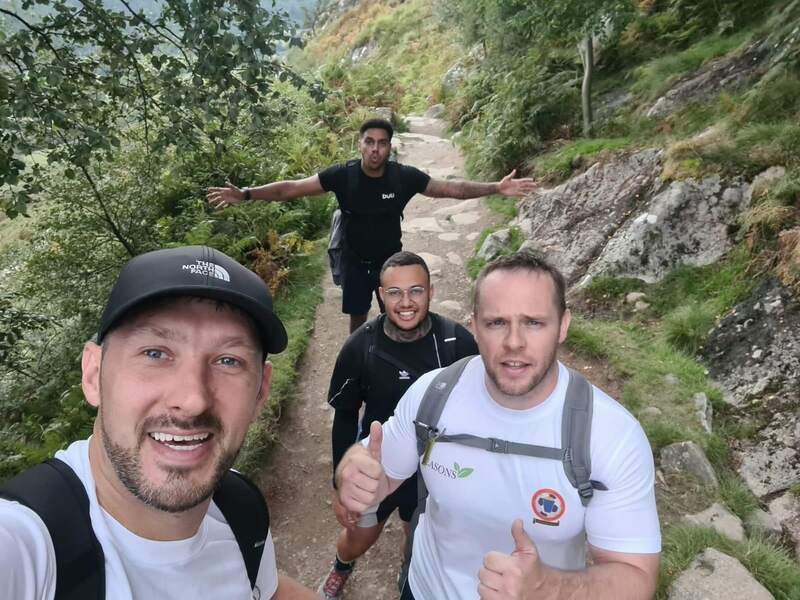 A group selfie on a steep mountain path