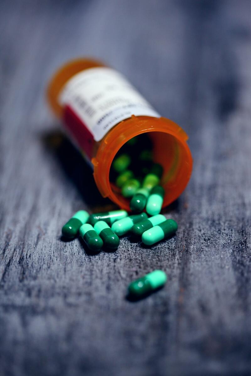 A prescription bottle with capsules